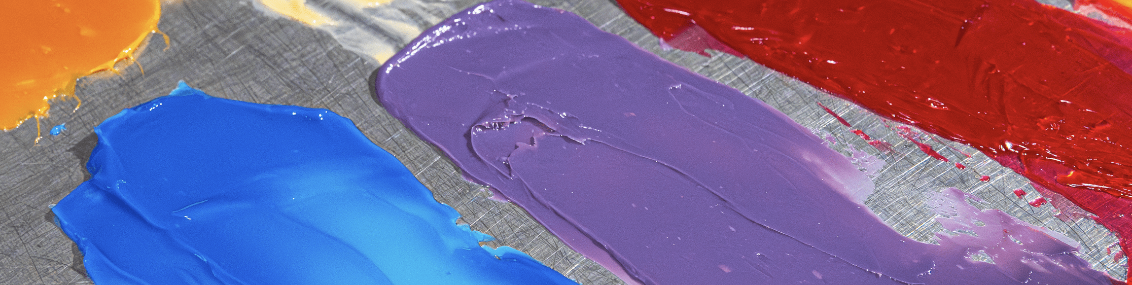 Color palette with vibrant orange, blue, purple, and red swatches on textured surface.